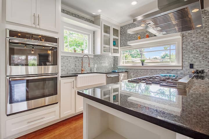 An image of a modern kitchen with sleek appliances, featuring a gas stove, refrigerator, and built-in microwave in Carrollton